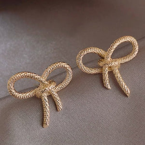 Gold Tone Bow Stud Earrings E175